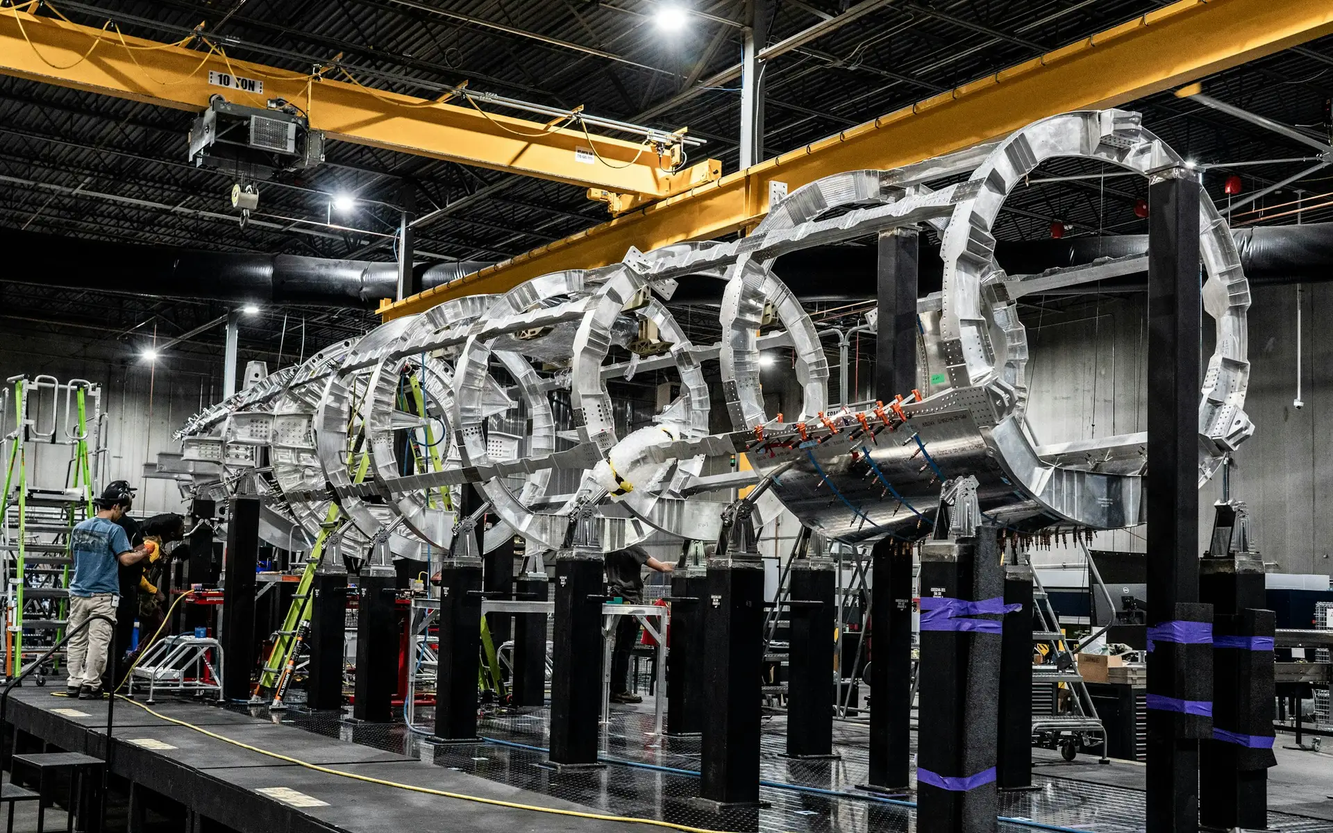 Aircraft fuselage structure being assembled in a modern engineering facility